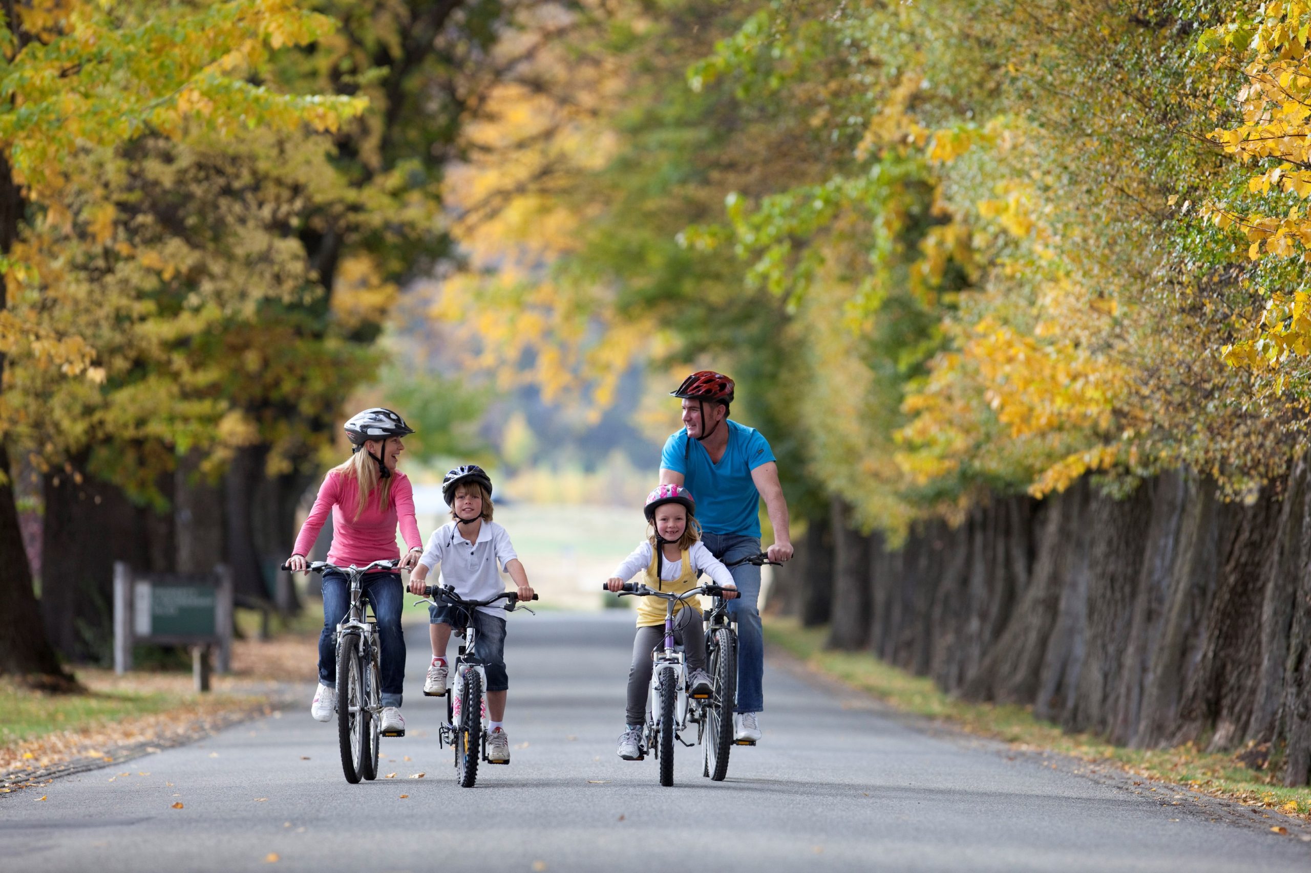 Family biking in Arrowtown in Autumn